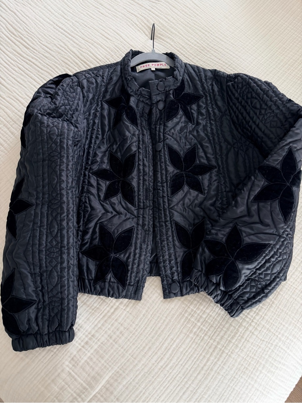 This is a black Free People Quinn quilted jacket